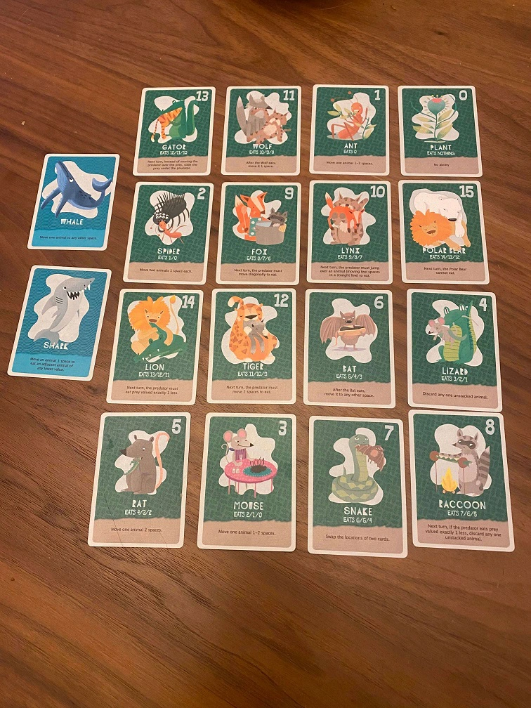 The Food Chain Island Board On the left, 2 blue cards representing the sea creatures. On the right 16 cards in a 4x4 grid representing the land creatures.