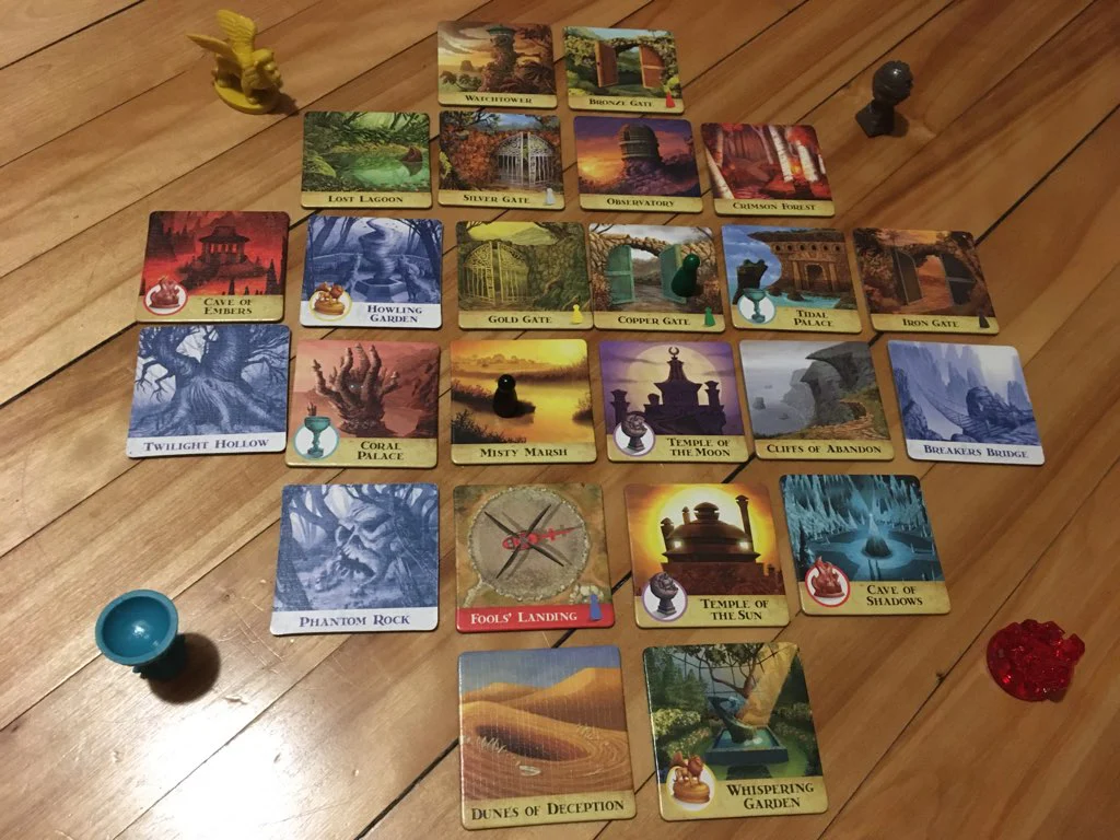 The Entire Game Board A top down view of the entire gameboard with each of the main components on either side. Some of the tiles have been flipped over.